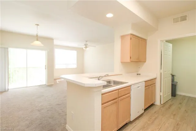 a kitchen with a refrigerator sink stove and cabinets