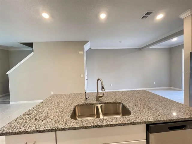 a kitchen with kitchen island a sink and a counter top