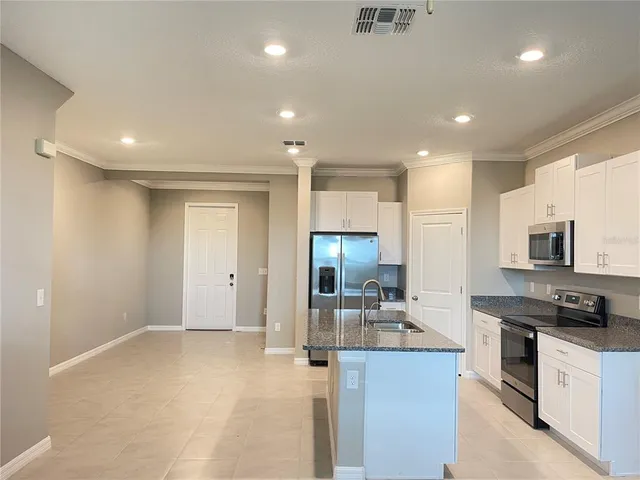 a kitchen with stainless steel appliances granite countertop a stove and a sink