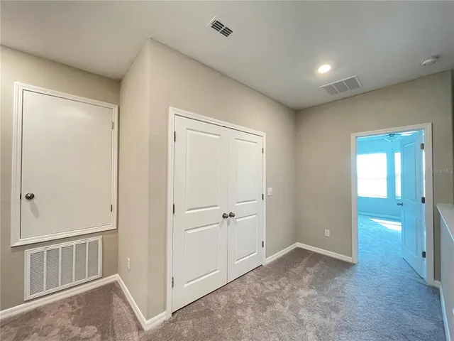 an empty room with closet area