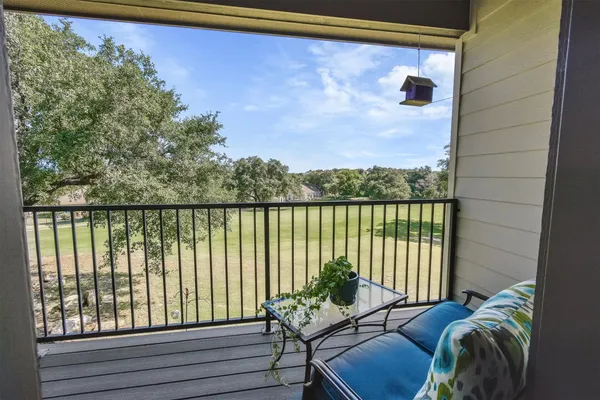 a balcony with furniture and a potted plant