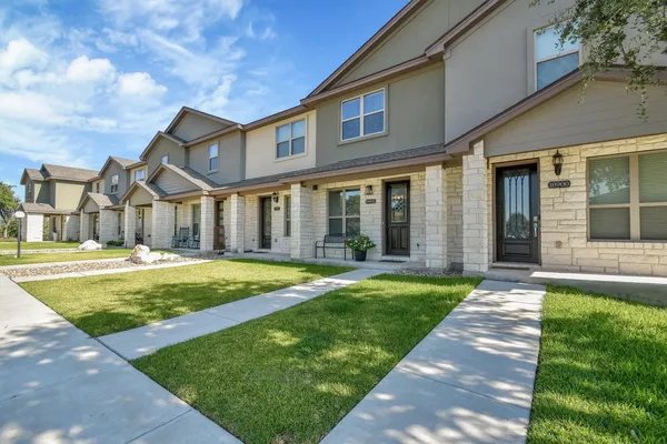 a front view of a house with a yard
