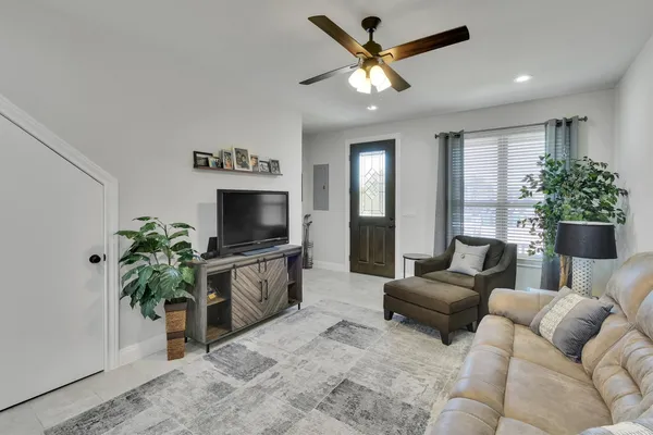 a living room with furniture and a flat screen tv