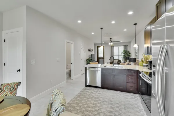 a kitchen with a sink appliances and cabinets