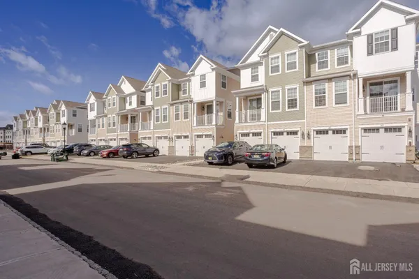 a view of a street that has couple of cars parked on the road
