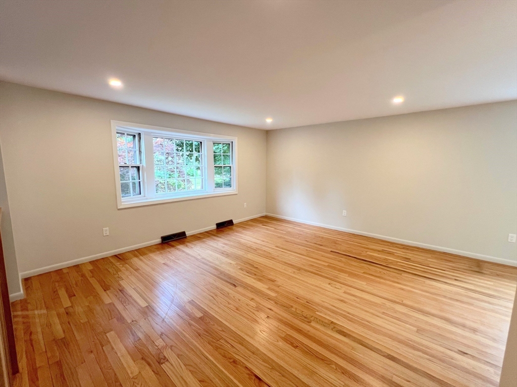 67 Hall Road Chelmsford, MA 01824 - Photo 11 of 35 an empty room with wooden floor and windows