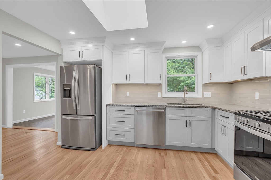 67 Hall Road Chelmsford, MA 01824 - Photo 2 of 35 a kitchen with a refrigerator cabinets and wooden floor