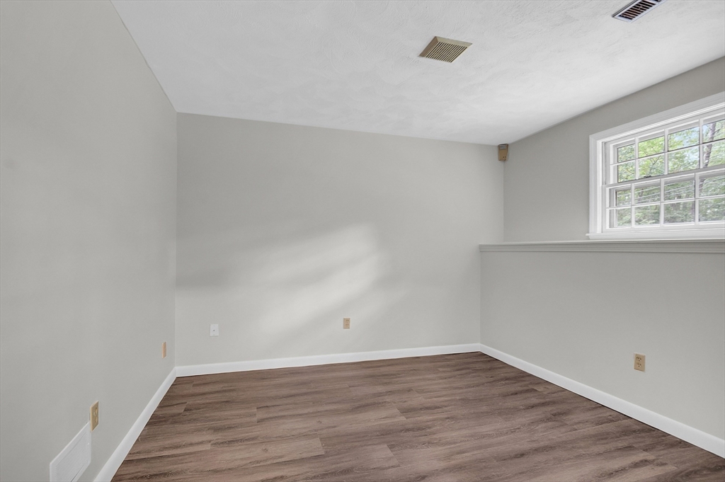 67 Hall Road Chelmsford, MA 01824 - Photo 26 of 35 wooden floor in an empty room with a window
