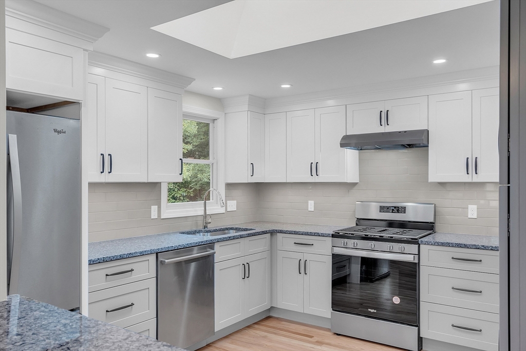 67 Hall Road Chelmsford, MA 01824 - Photo 3 of 35 a kitchen with white cabinets stainless steel appliances and sink