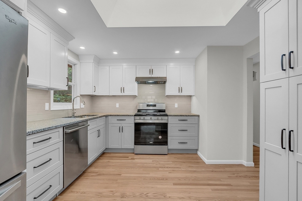 67 Hall Road Chelmsford, MA 01824 - Photo 4 of 35 a kitchen with stainless steel appliances granite countertop a stove top oven and sink