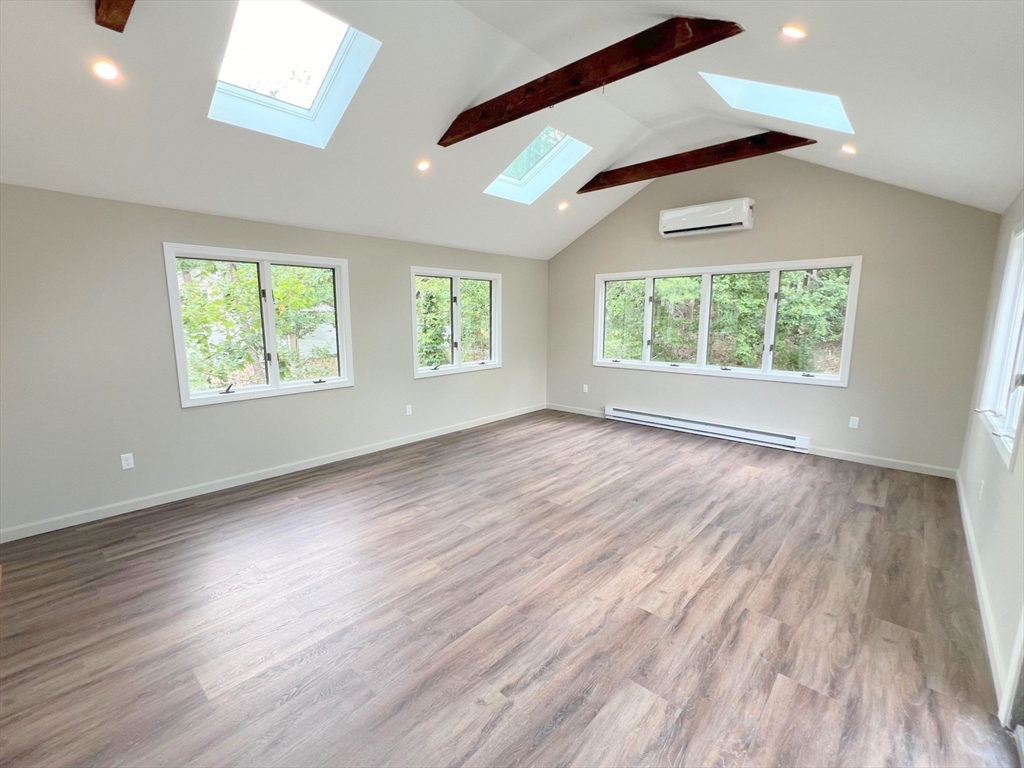 67 Hall Road Chelmsford, MA 01824 - Photo 6 of 35 an empty room with wooden floor and windows