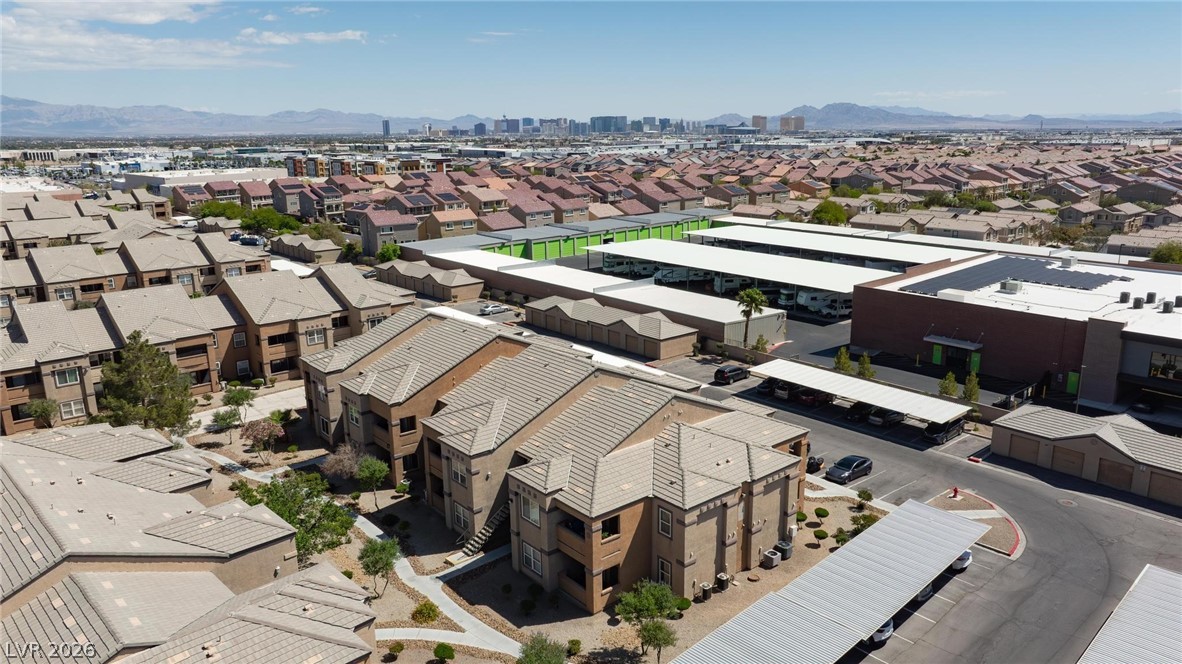 6650 West Warm Springs Road, Unit 2027 Las Vegas, NV 89118 - Photo 27 of 29 An aerial view captures the expansive community with diverse structures and distant mountains.