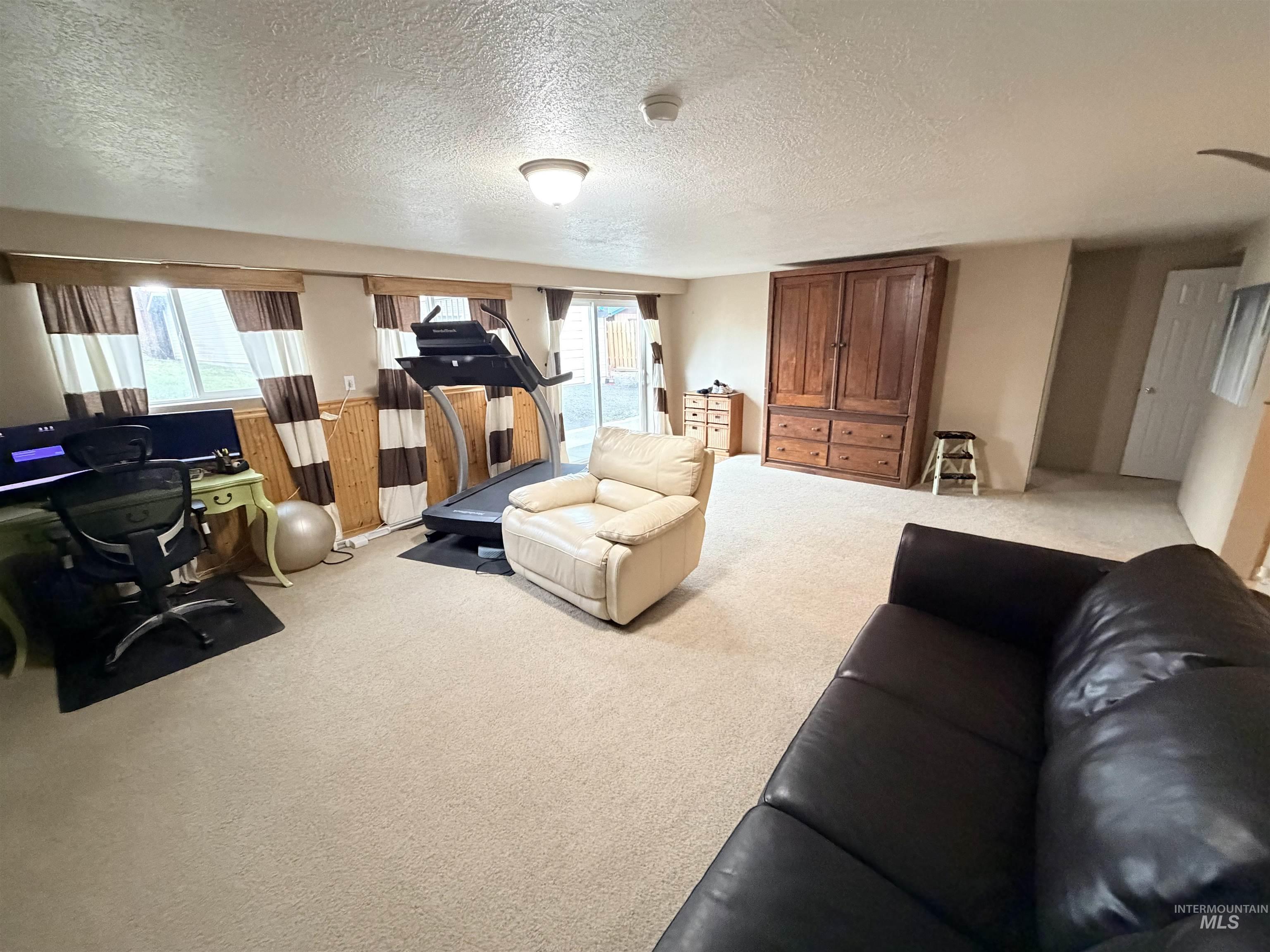 1306 Hemlock Avenue Lewiston, ID 83501 - Photo 20 of 38 Living room with carpet floors, a textured ceiling, and a desk