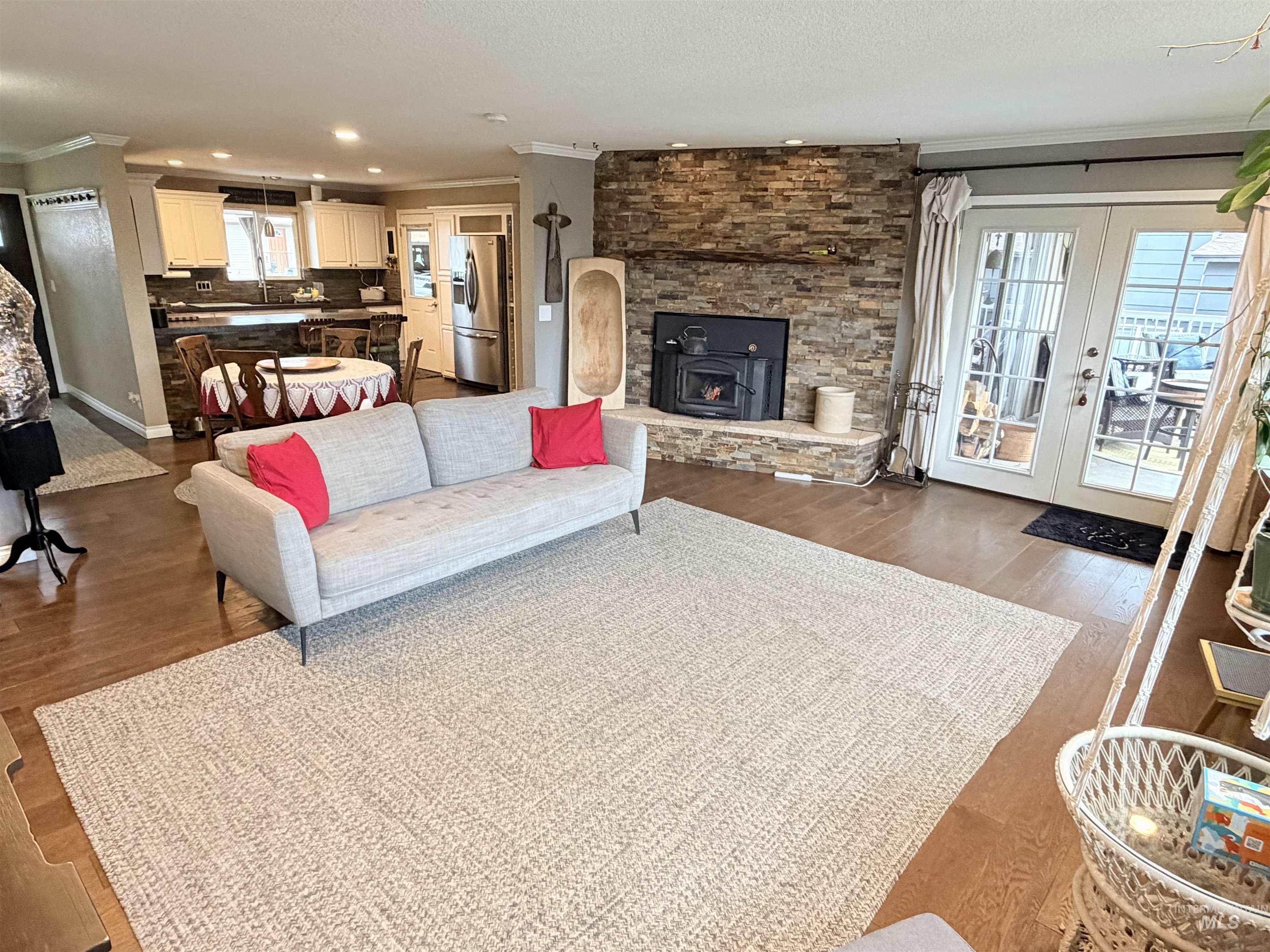 1306 Hemlock Avenue Lewiston, ID 83501 - Photo 6 of 38 Living room with crown molding, french doors, wood finished floors, recessed lighting, and a wood stove