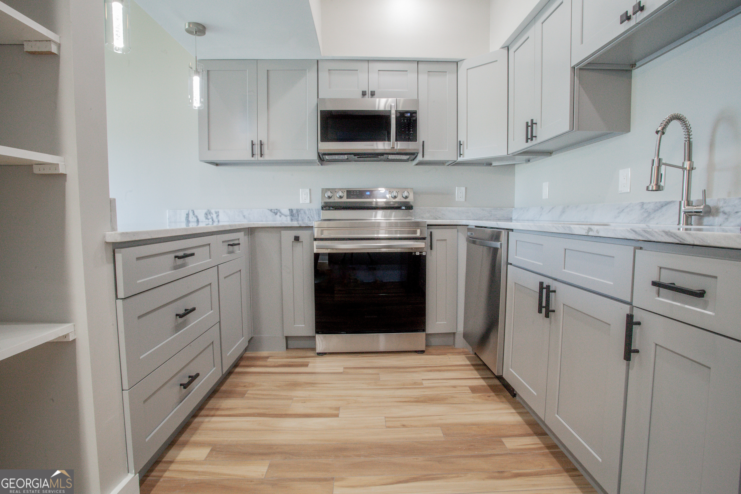 295 Clearview Court Villa Rica, GA 30180 - Photo 11 of 49 a kitchen with white cabinets and white appliances