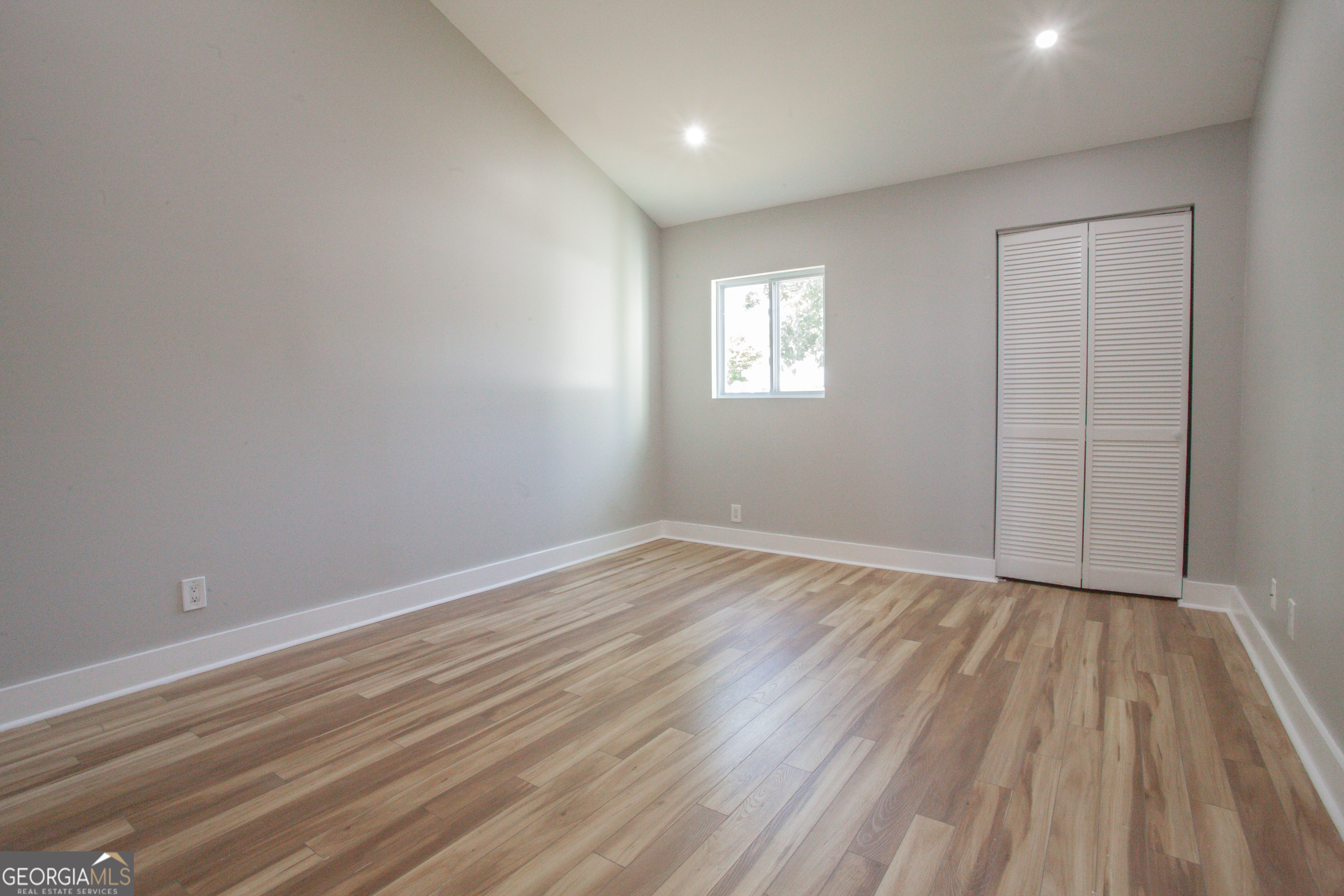 295 Clearview Court Villa Rica, GA 30180 - Photo 6 of 49 wooden floor in an empty room with a window