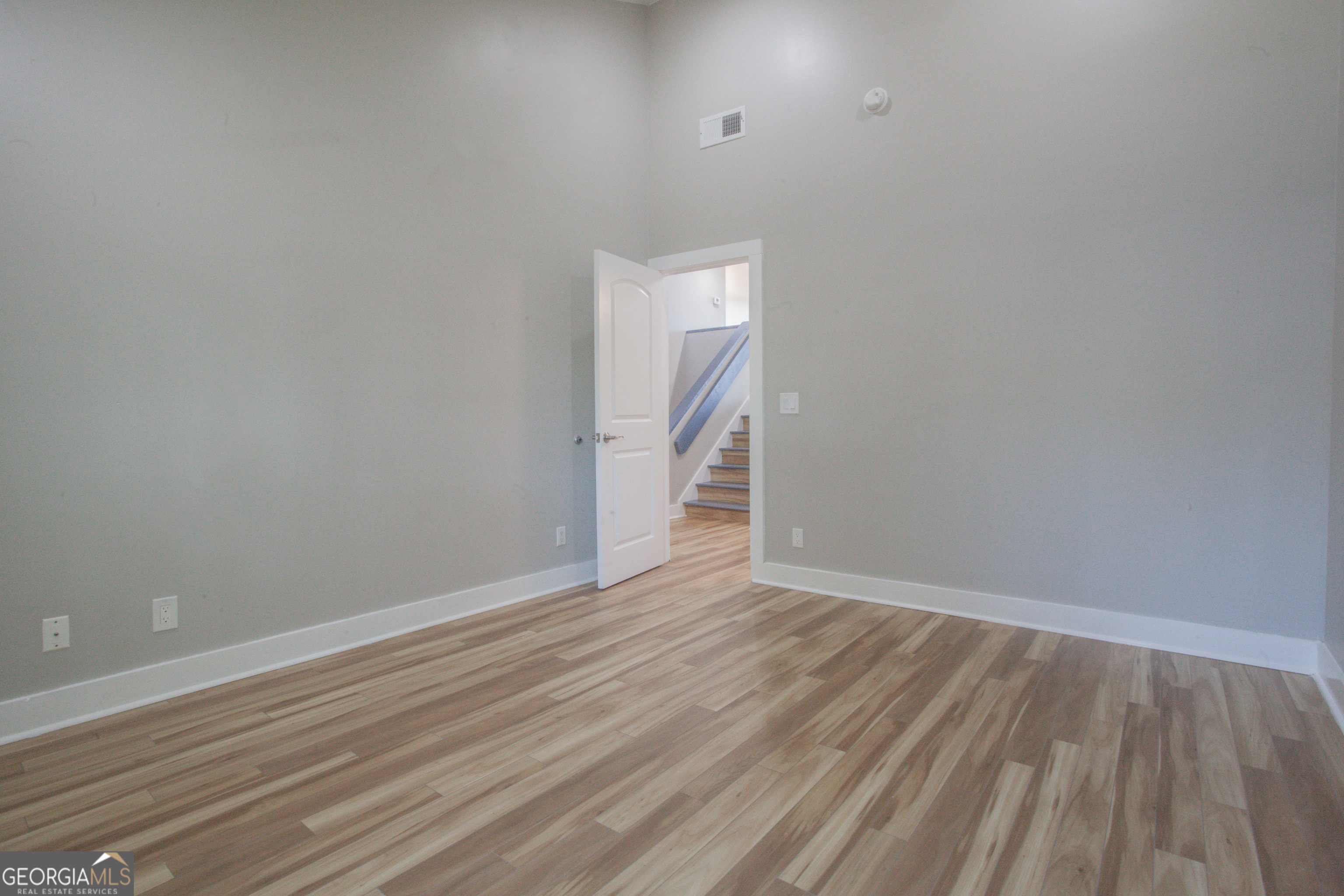 295 Clearview Court Villa Rica, GA 30180 - Photo 7 of 49 a view of an empty room with wooden floor and a window