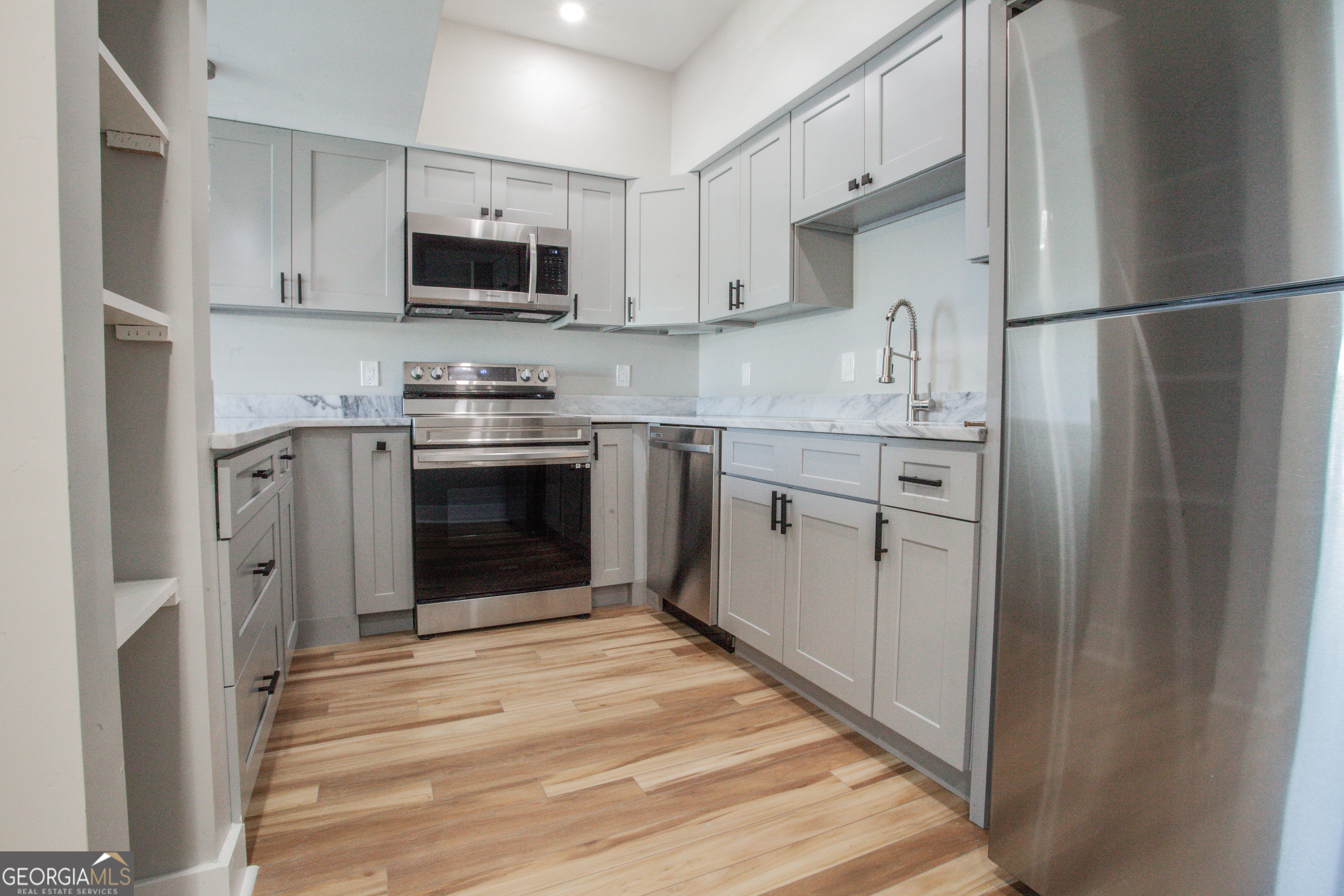 295 Clearview Court Villa Rica, GA 30180 - Photo 10 of 49 a kitchen with stainless steel appliances granite countertop a stove a refrigerator and a microwave