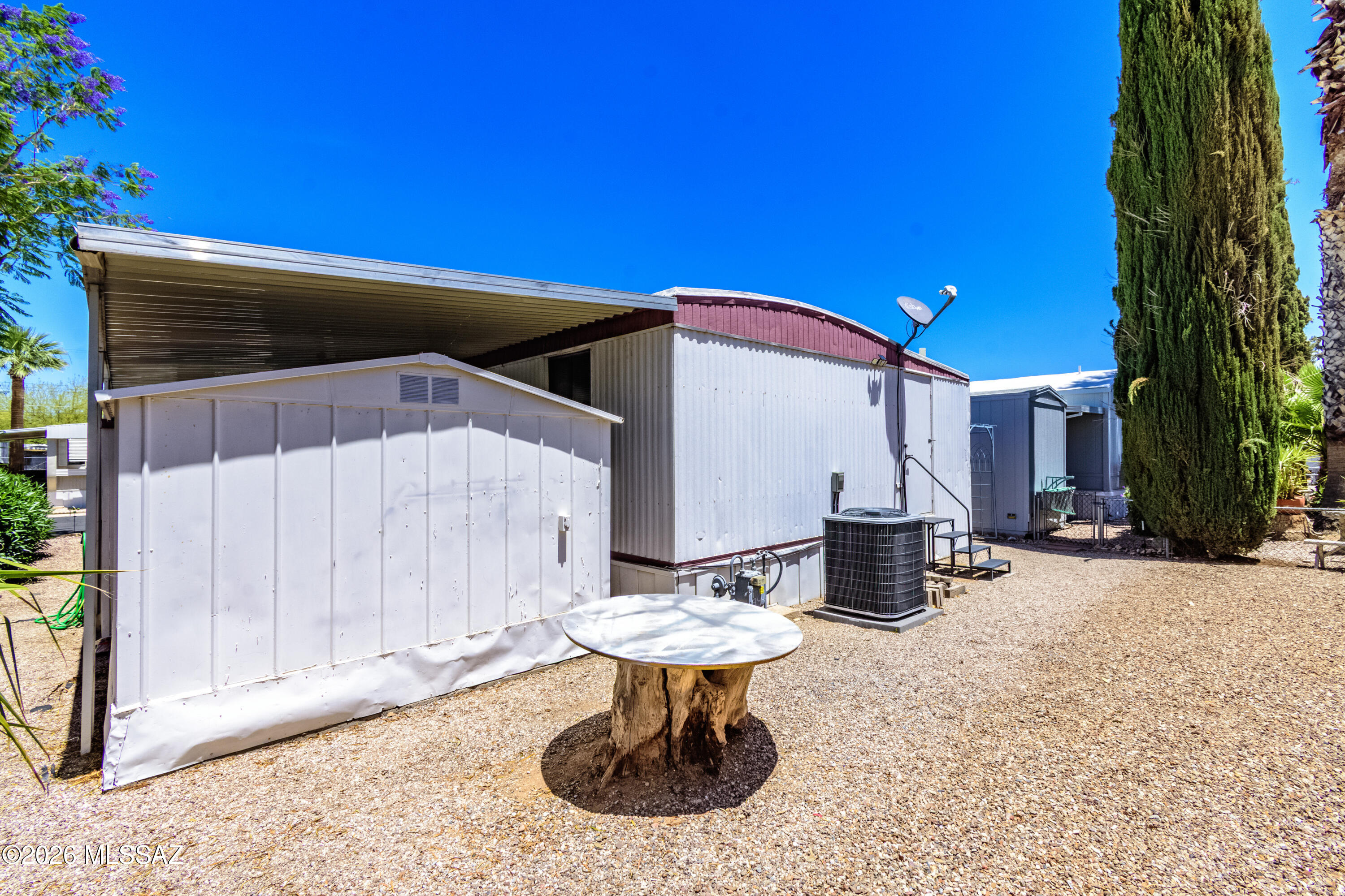 4550 North Flowing Wells Road, Unit 155 Tucson, AZ 85705 - Photo 9 of 40 a backyard of a house with table and chairs