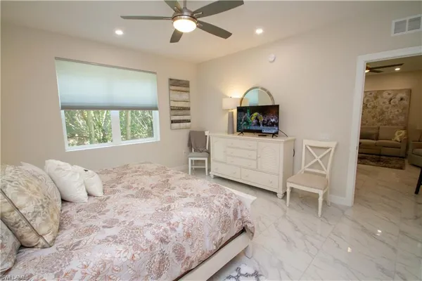 a bedroom with a bed and a dresser