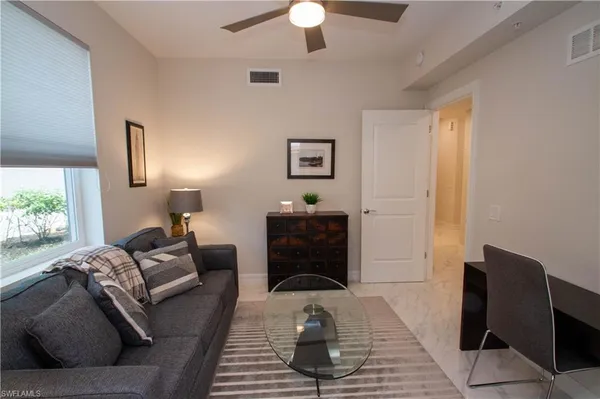 a living room with furniture and a window