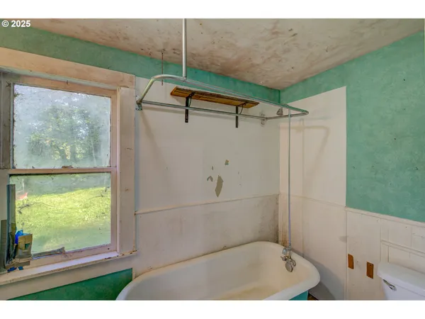 a bathroom with a sink mirror and a window