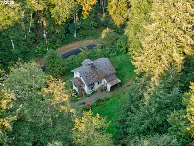 an aerial view of a house with a yard and lake view