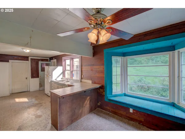 a kitchen with a stove a sink and a window