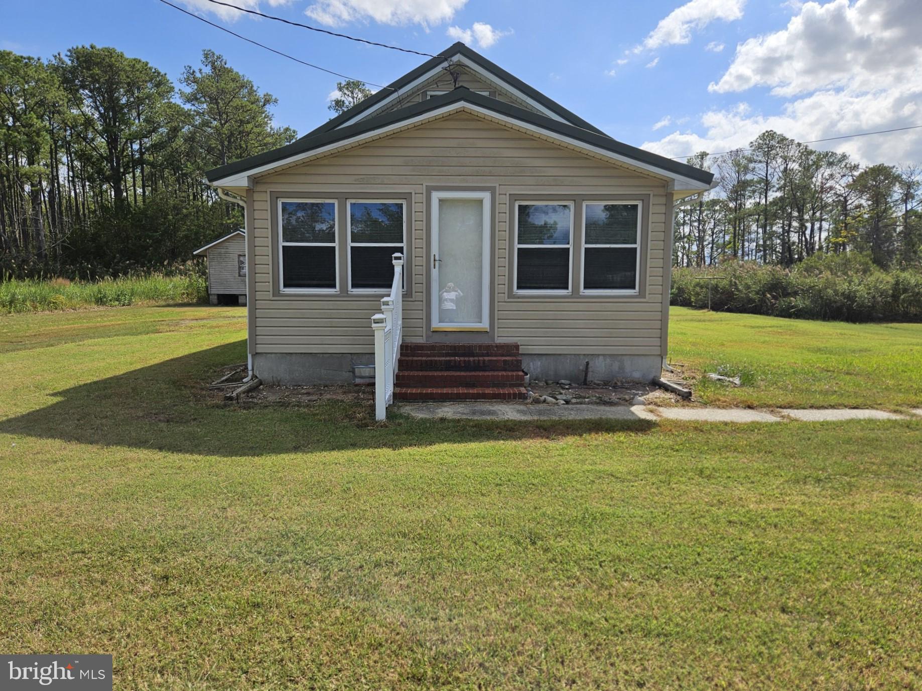 2796 Calvary Road Crisfield, MD 21817 - Photo 3 of 17 a front view of a house with a yard