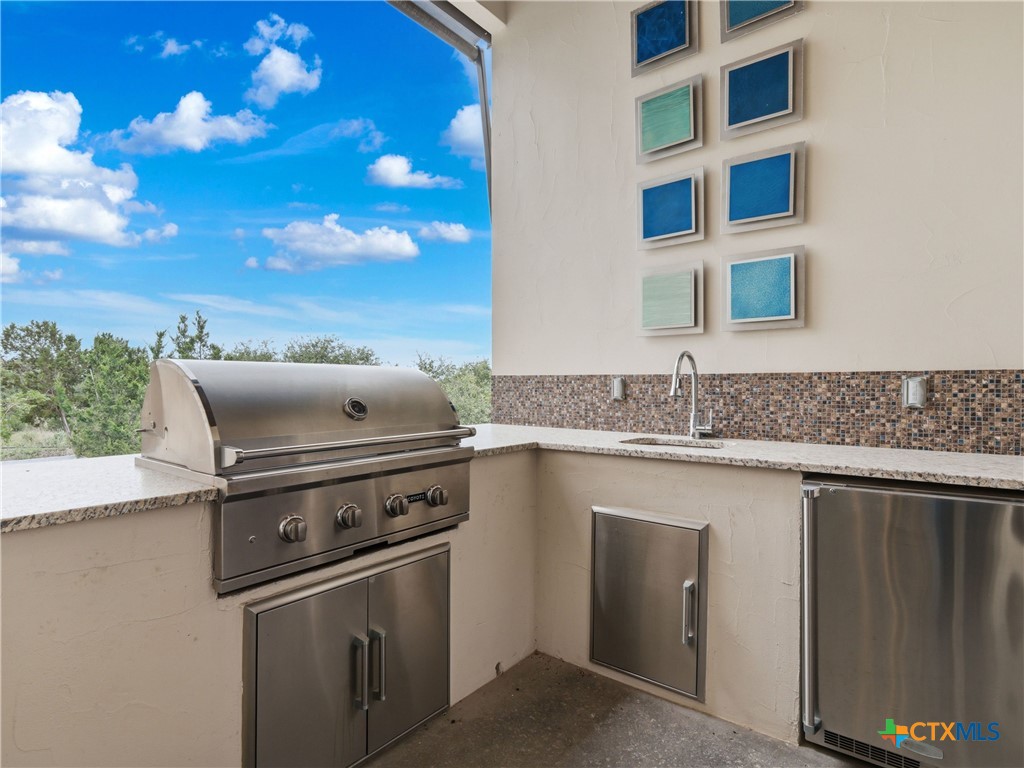 5913 Verden Ridge New Braunfels, TX 78132 - Photo 32 of 48 a close view of a stove top oven and utility