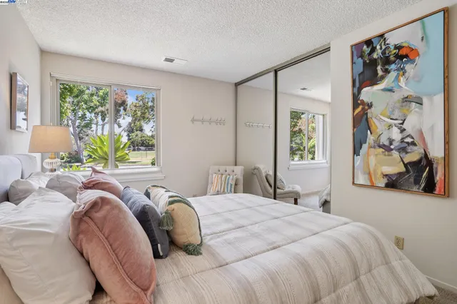 a bedroom with a large bed and a window