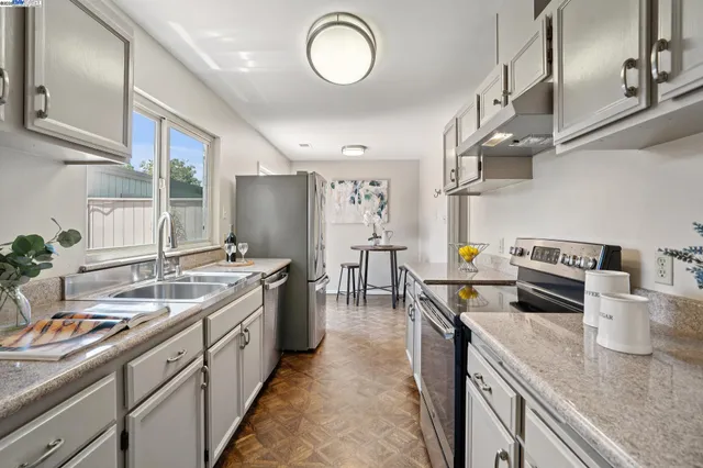a kitchen with a sink stove and cabinets