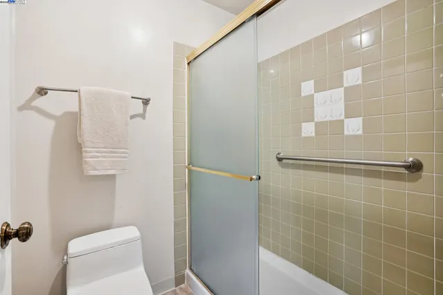 a bathroom with a toilet and shower