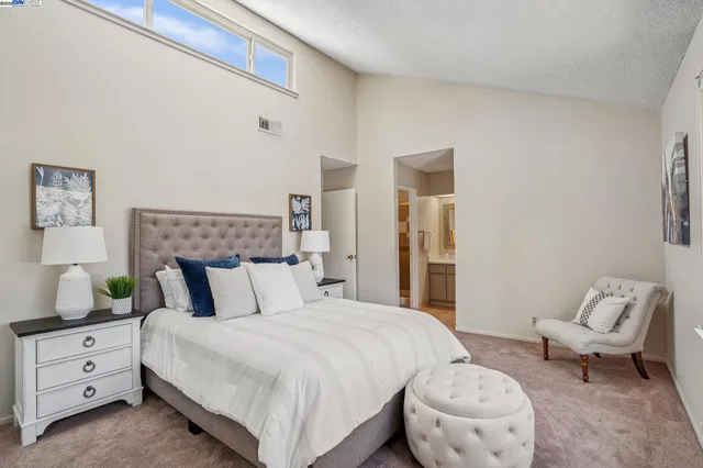 a bedroom with a bed and a couch