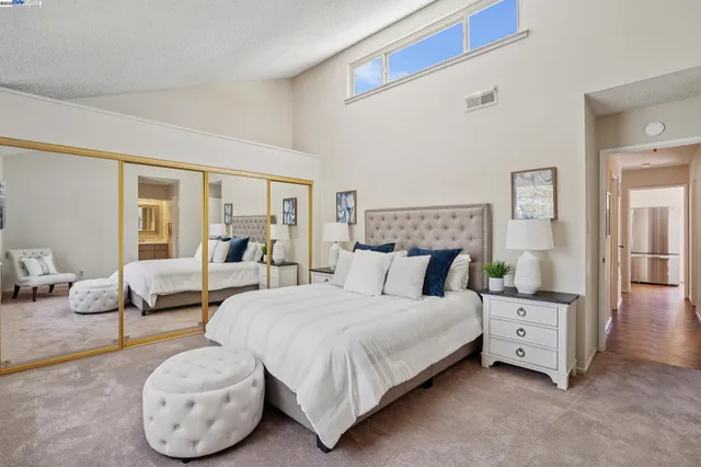 a bedroom with bed and a couch