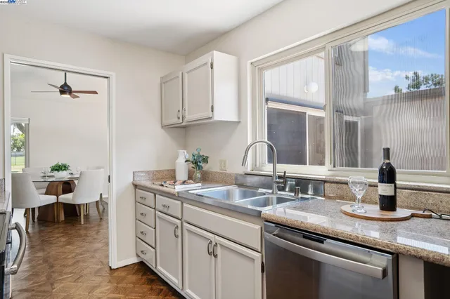 a kitchen with sink and cabinets