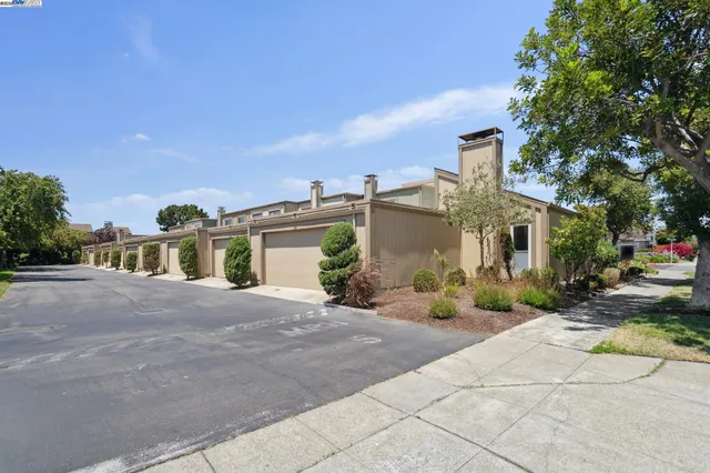 a view of a house with sitting area and garden