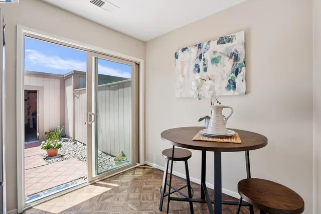 a view of a room that has a table and chairs in it