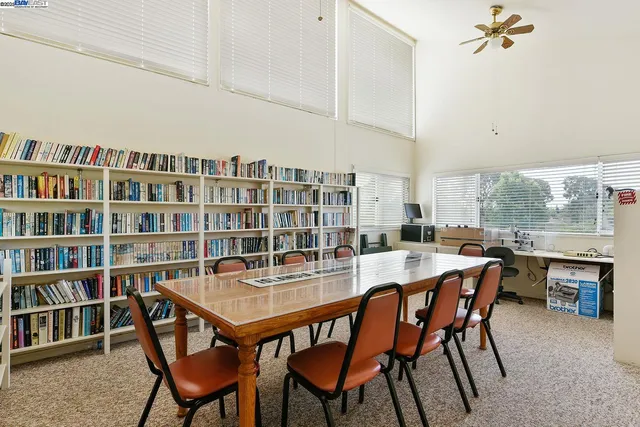 a dining room with a wooden table and chairs