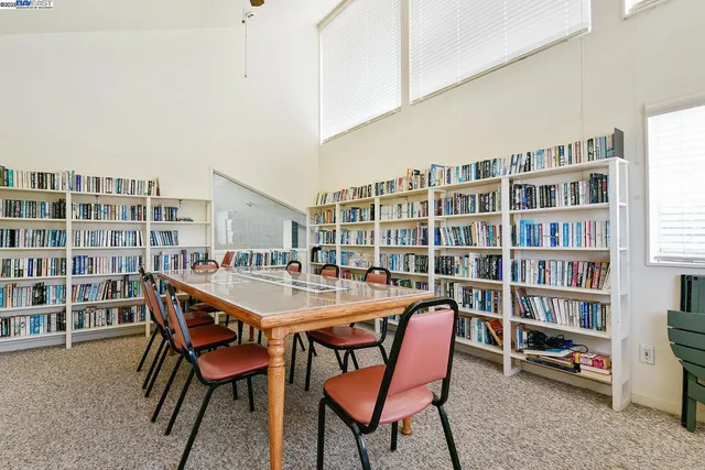 a dining room with a bookshelf and a wooden floor