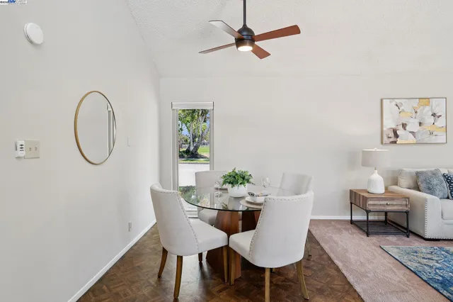 a view of a dining room with furniture and a potted plant