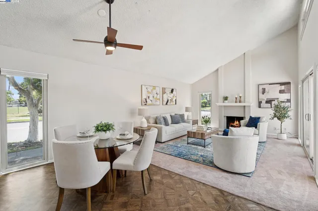 a living room with fireplace furniture and a chandelier