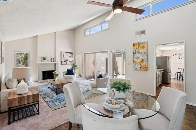 a living room with furniture a fireplace and a table