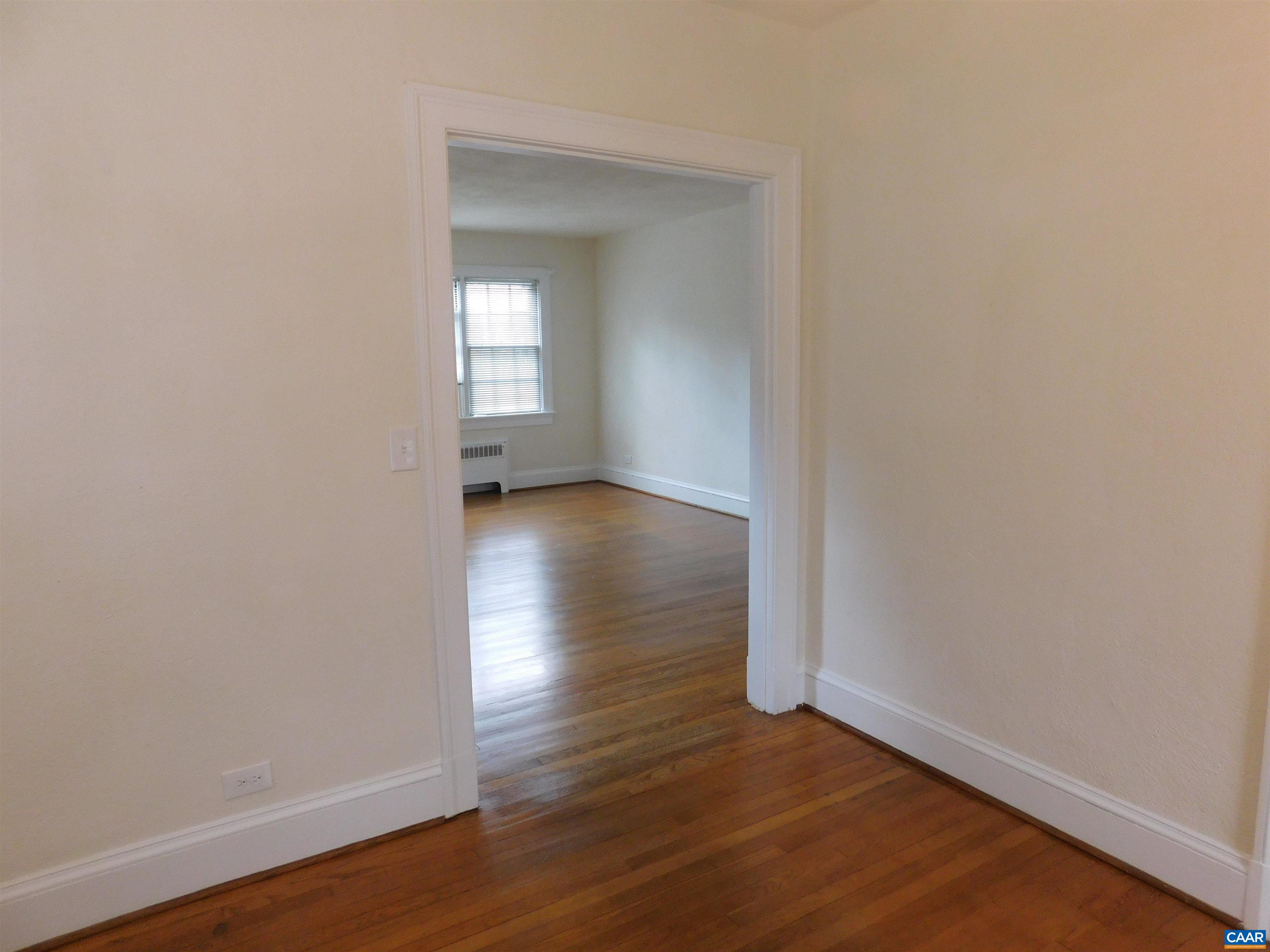 307 Alderman Road Charlottesville, VA 22903 - Photo 13 of 41 an empty room with wooden floor and mirror