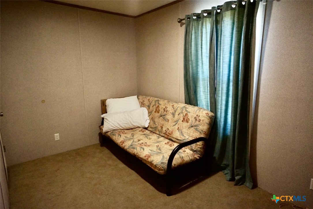 1502 West Monroe Avenue Port O'Connor, TX 77982 - Photo 17 of 22 a view of bedroom with furniture and window