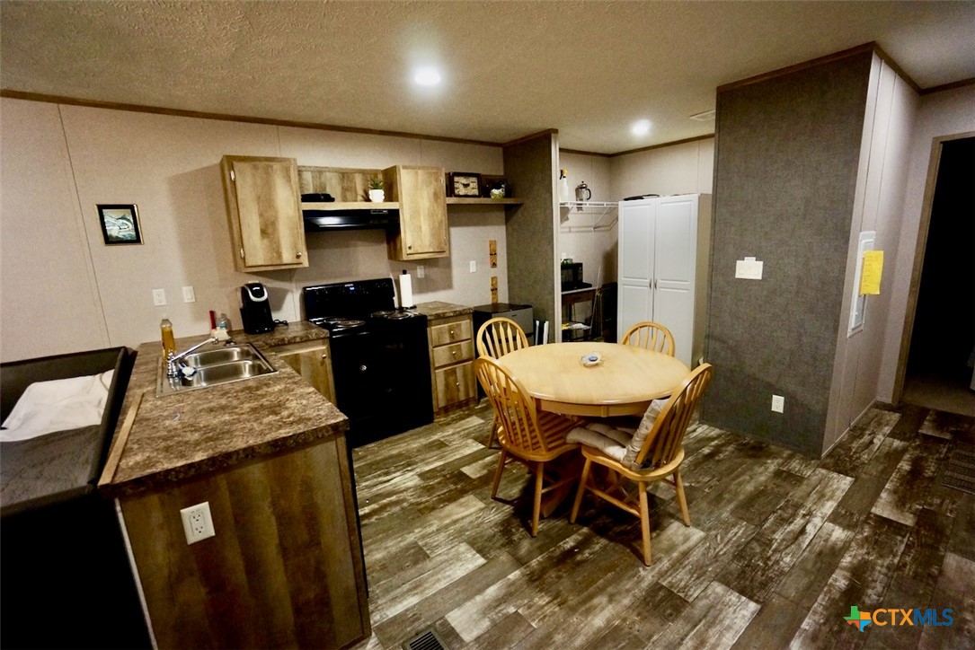 1502 West Monroe Avenue Port O'Connor, TX 77982 - Photo 19 of 22 a kitchen with a table and chairs in it