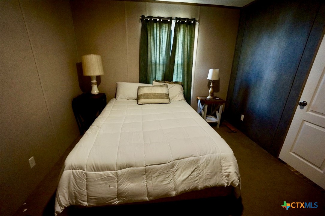 1502 West Monroe Avenue Port O'Connor, TX 77982 - Photo 20 of 22 a bedroom with a bed and a mirror