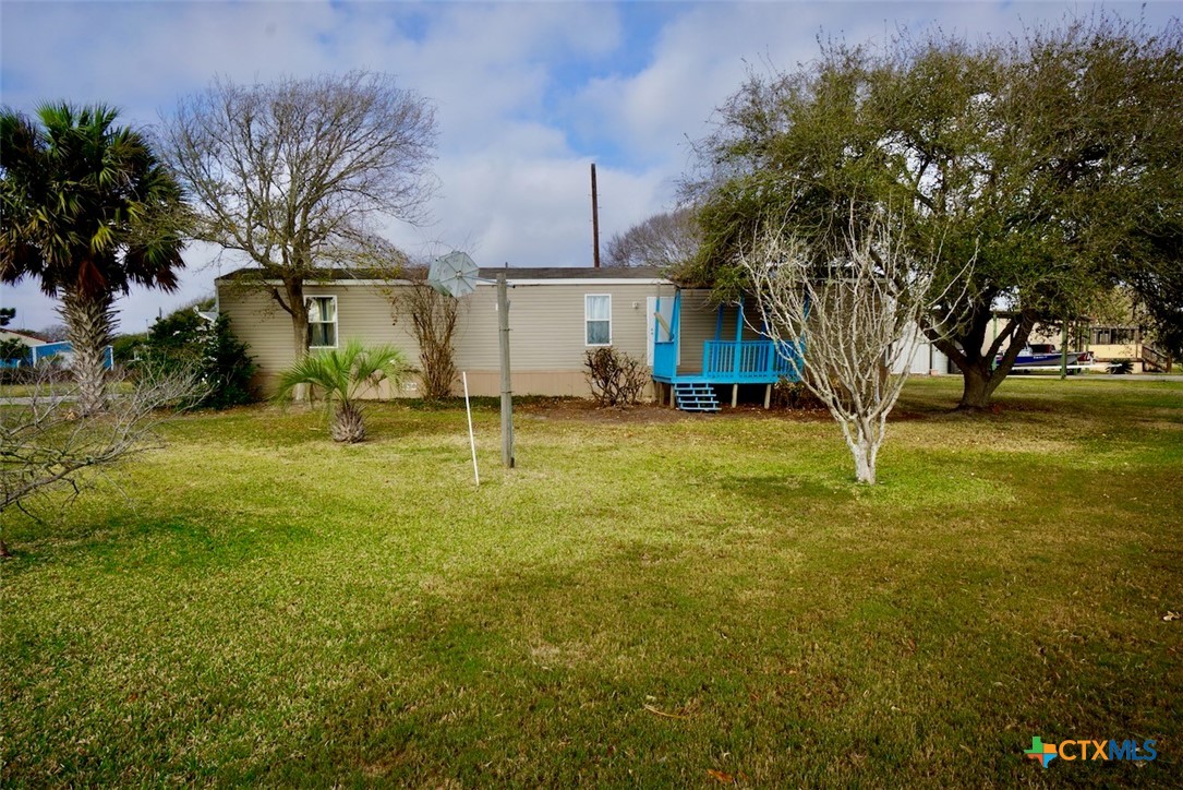 1502 West Monroe Avenue Port O'Connor, TX 77982 - Photo 2 of 22 a view of a yard in front of house