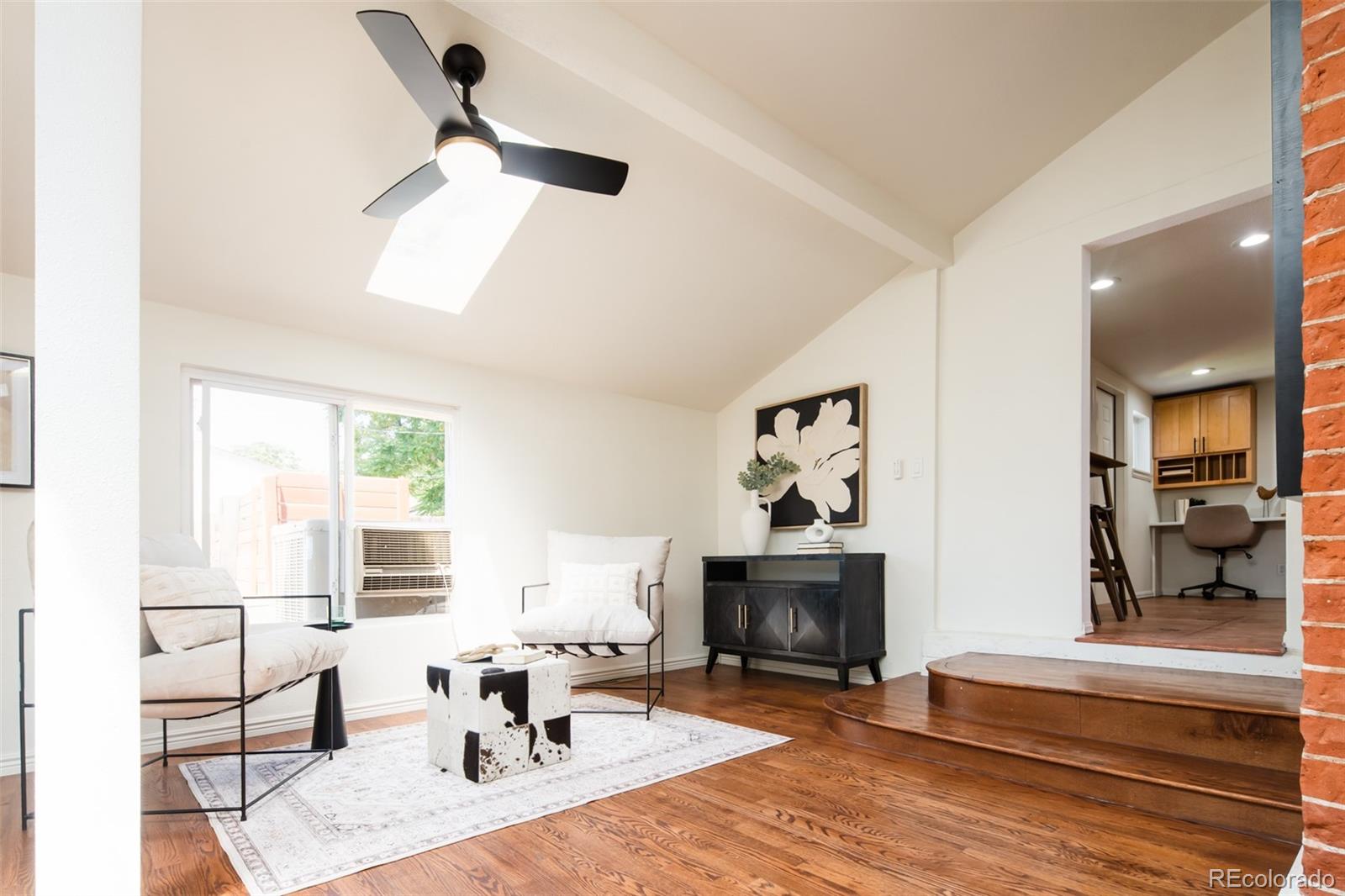 3519 L Newton Street Denver, CO 80211 - Photo 14 of 40 a living room with furniture a fireplace and a flat screen tv