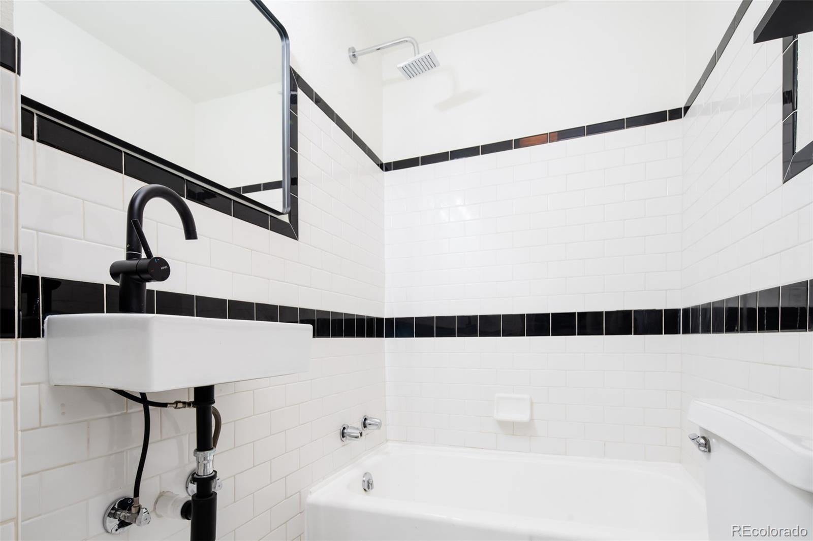 3519 L Newton Street Denver, CO 80211 - Photo 21 of 40 a bathroom with a bathtub and shower